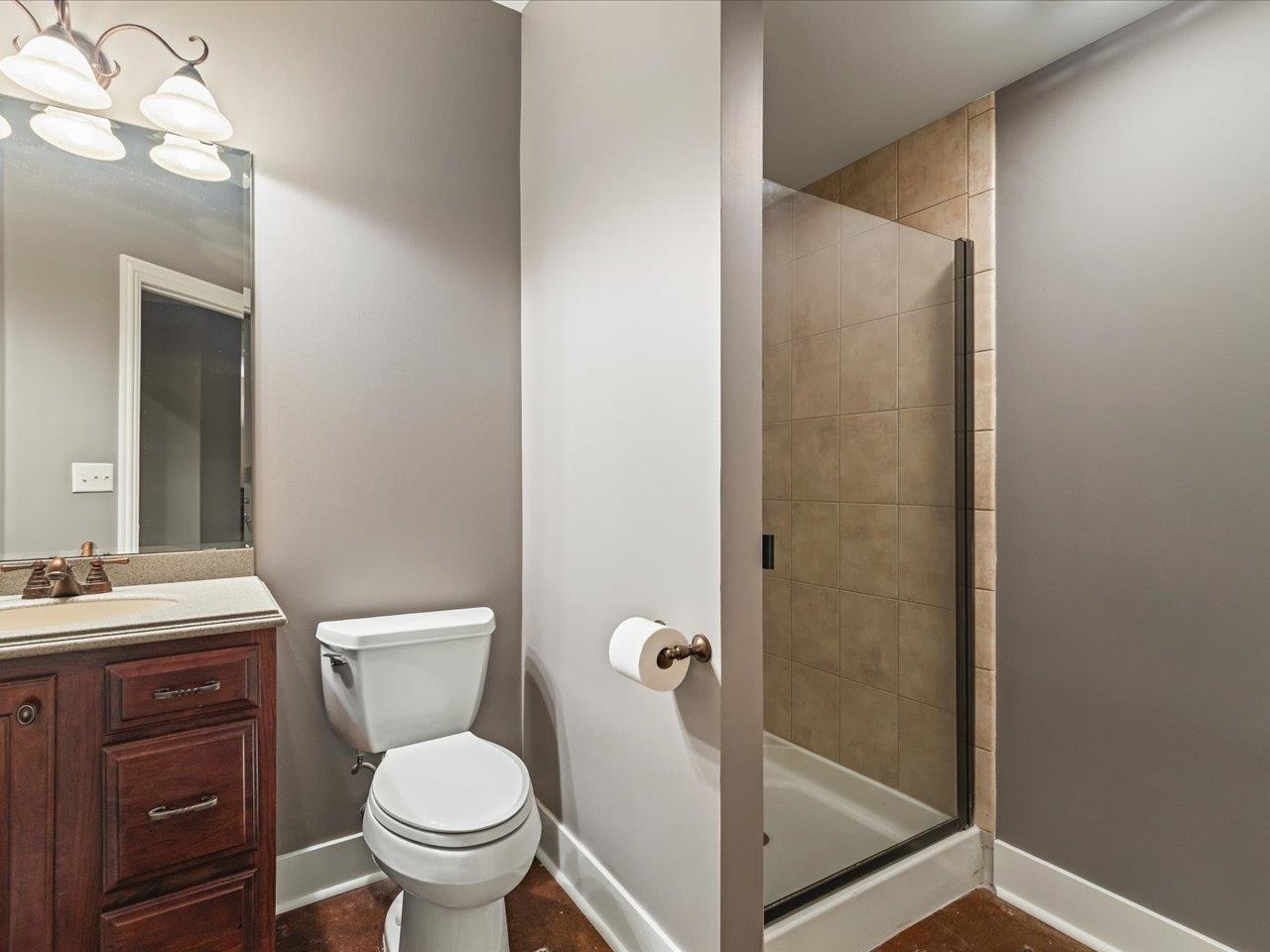 12936 Melrose Road Caledonia, IL 61011 - Photo 65 of 94 a bathroom with a toilet a sink and mirror