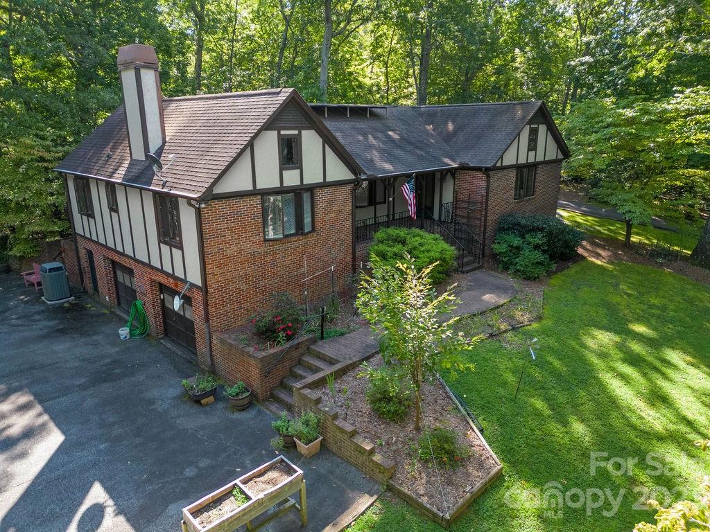 330 Beau Valley Road Tryon, NC 28782 - Photo 1 of 42 a aerial view of a house with yard and trees in the background