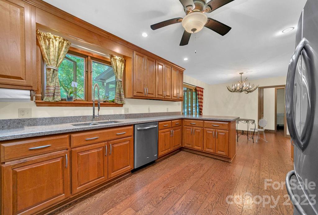 330 Beau Valley Road Tryon, NC 28782 - Photo 16 of 42 a kitchen with stainless steel appliances granite countertop wooden floors a stove and a granite counter tops with a large window