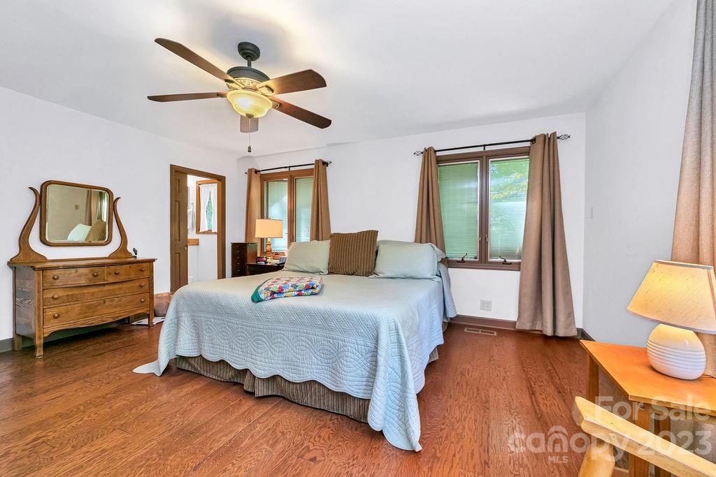 330 Beau Valley Road Tryon, NC 28782 - Photo 21 of 42 a bedroom with a bed and wooden floor