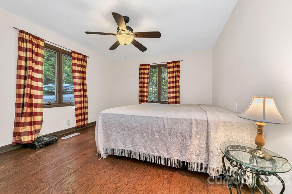 330 Beau Valley Road Tryon, NC 28782 - Photo 24 of 42 a bedroom with a bed and dresser with wooden floor