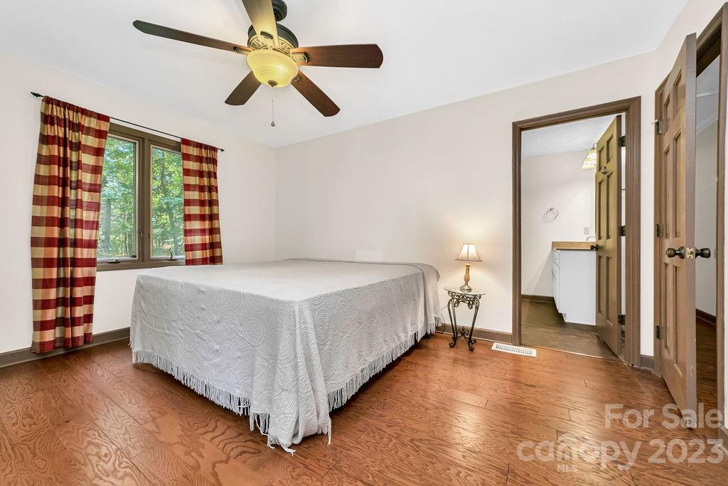330 Beau Valley Road Tryon, NC 28782 - Photo 25 of 42 a spacious bedroom with a bed and a large window