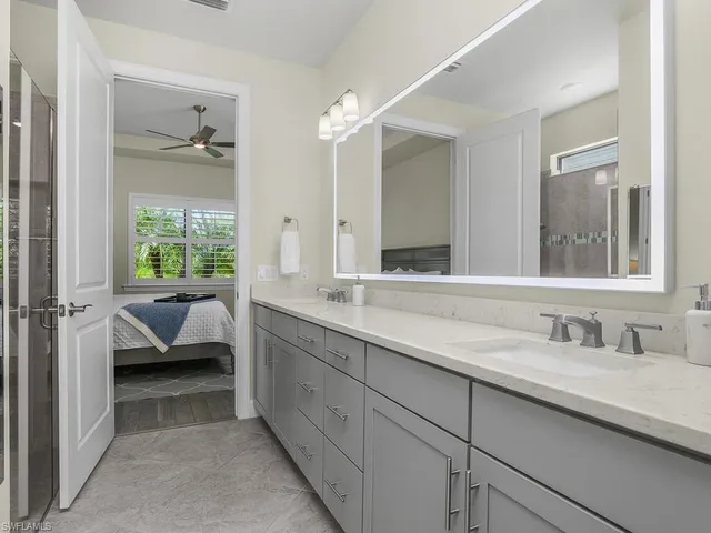 a bathroom with a double vanity sink and a mirror