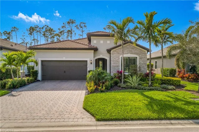 a front view of a house with a garden and plants