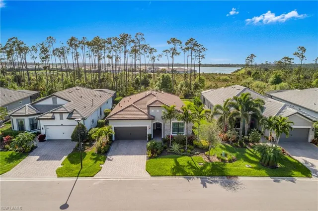 a front view of a house with a yard and a garage