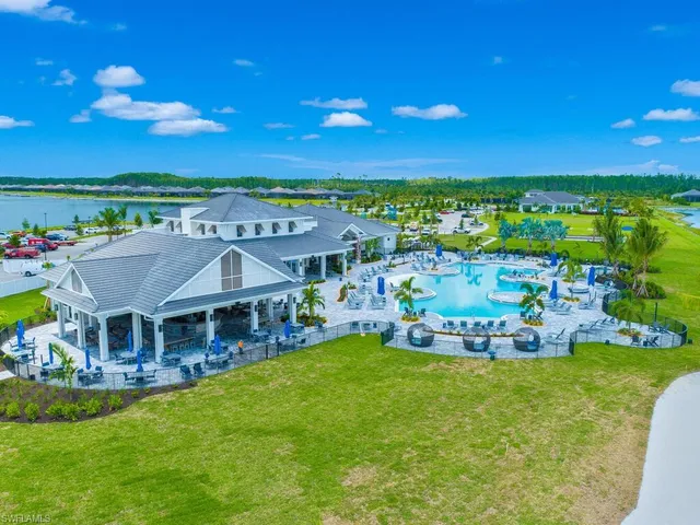 a view of a house with pool and chairs