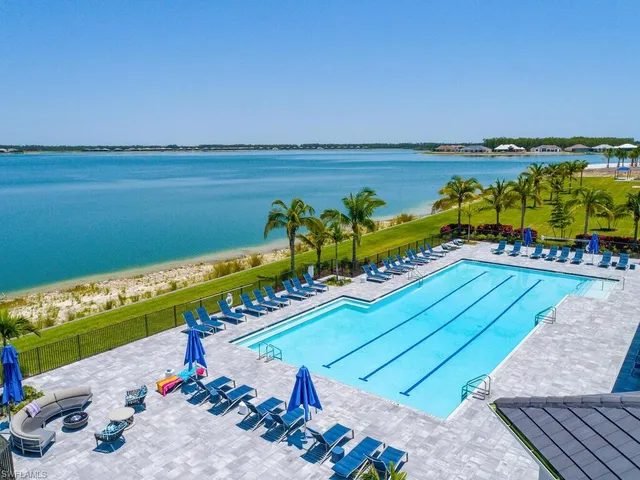 an aerial view of a house with a swimming pool outdoor seating and yard