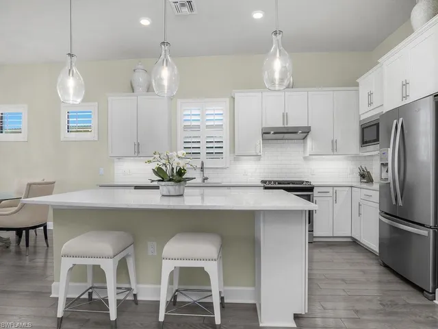 a room with lots of wooden furniture and a large window