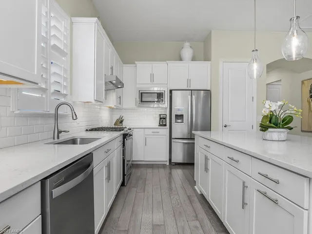 a kitchen with cabinets a sink and appliances