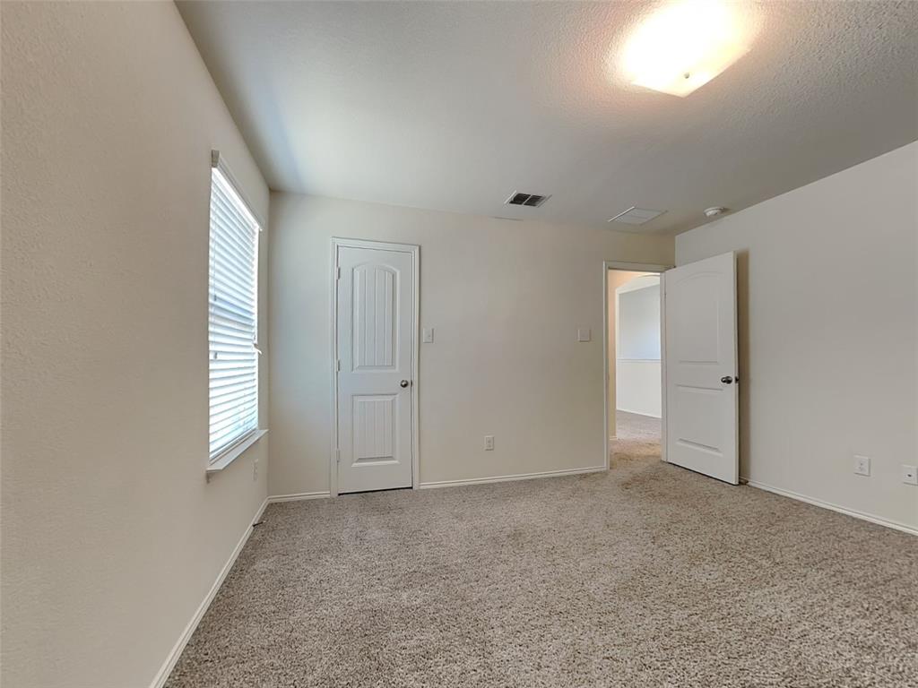 506 Robinson Way Fate, TX 75189 - Photo 17 of 30 Unfurnished bedroom featuring light colored carpet and baseboards