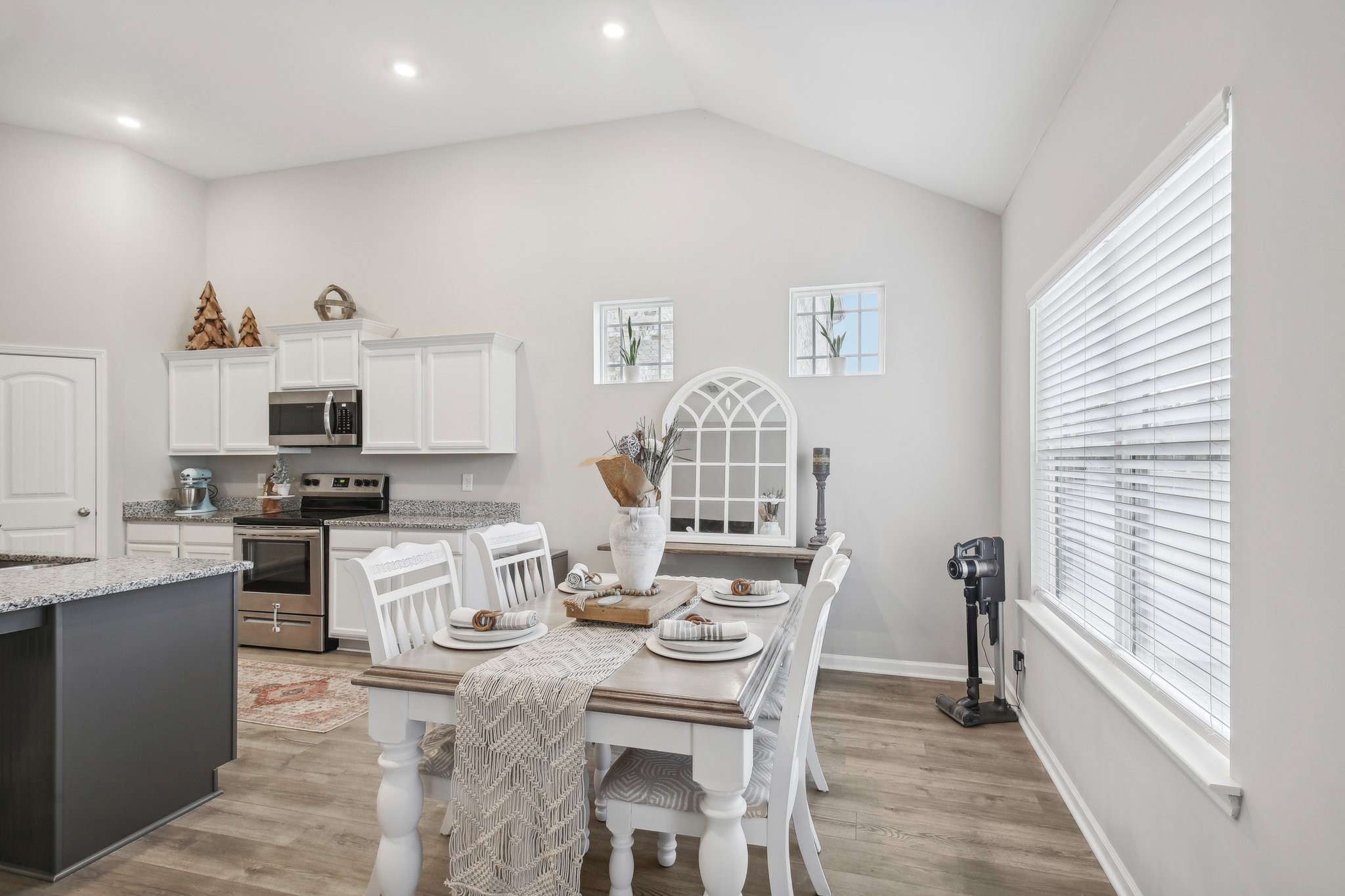 211 Thorpe Dr Spring Hill Spring Hill, TN 37174 - Photo 12 of 38 a open dining room with stainless steel appliances kitchen island granite countertop a table and chairs