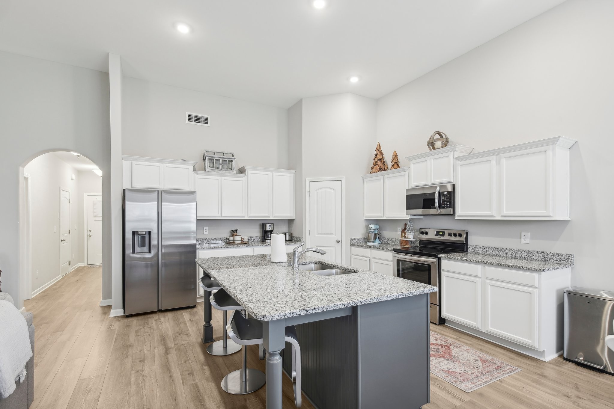 211 Thorpe Dr Spring Hill Spring Hill, TN 37174 - Photo 15 of 38 a kitchen with stainless steel appliances granite countertop a sink stove refrigerator and cabinets