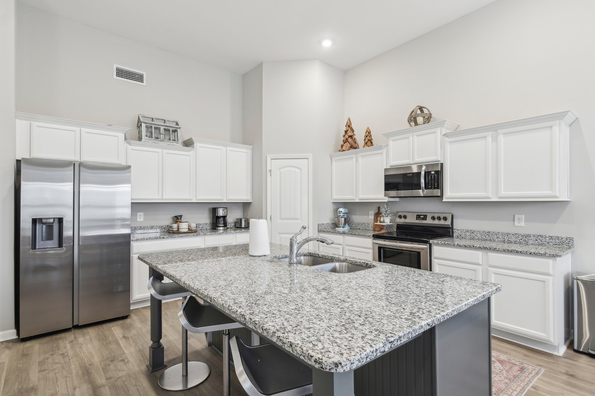 211 Thorpe Dr Spring Hill Spring Hill, TN 37174 - Photo 20 of 38 a kitchen with stainless steel appliances granite countertop a kitchen island hardwood floor sink and stove