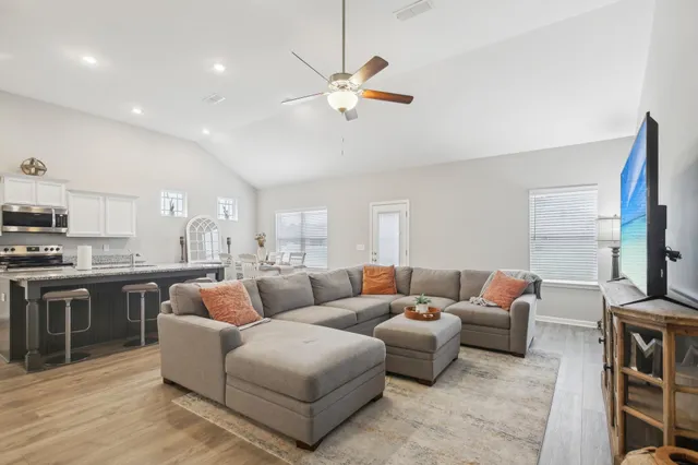 a living room with furniture a fireplace and a flat screen tv