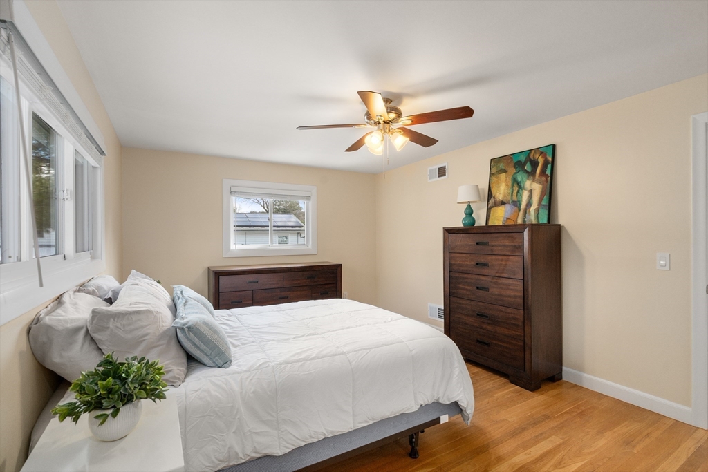 13 Berkeley Road Framingham, MA 01701 - Photo 12 of 32 a bedroom with a large bed and a chandelier