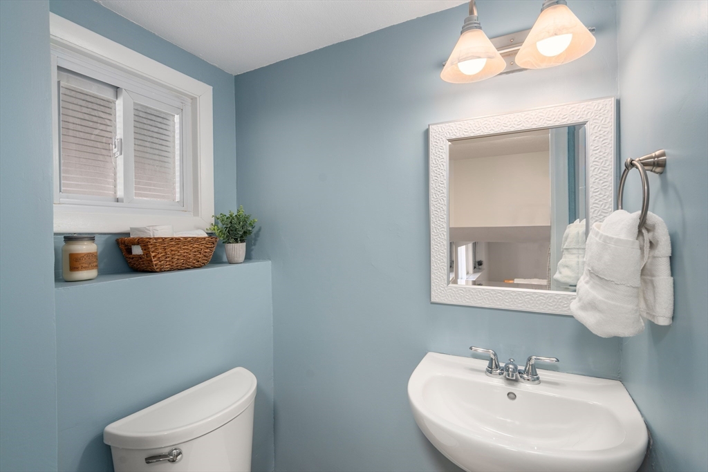 13 Berkeley Road Framingham, MA 01701 - Photo 18 of 32 a bathroom with a sink a toilet and mirror