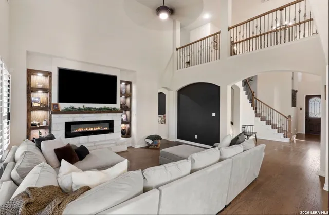 a living room with furniture a fireplace and a flat screen tv
