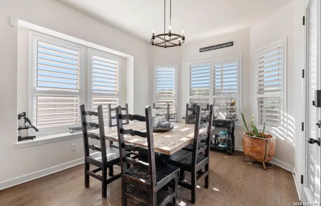 a view of a dining room with furniture and windows