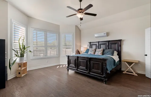 a bedroom with a bed and a large window