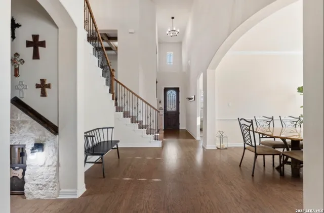a view of a hallway with wooden floor and stairs