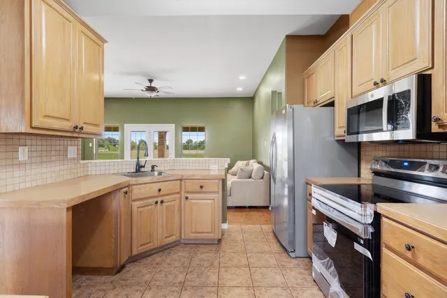 a kitchen with stainless steel appliances a sink dishwasher stove refrigerator and microwave