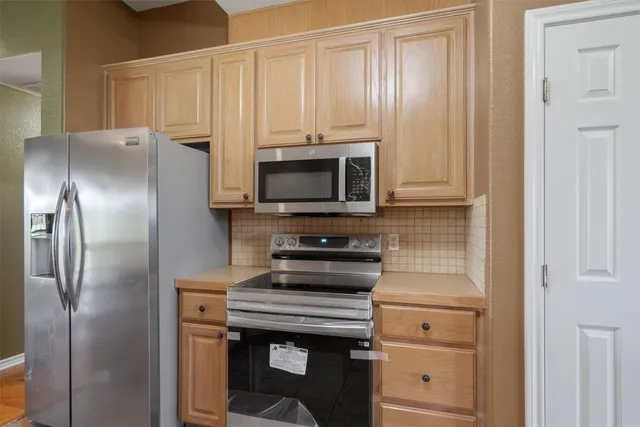 a kitchen with a stove microwave and refrigerator