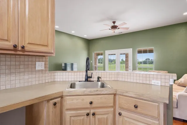 a kitchen with a sink cabinets and window