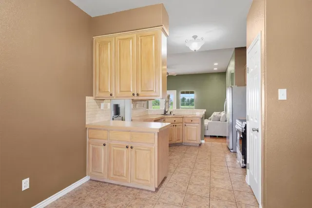 a large white room with a mirror and a sink