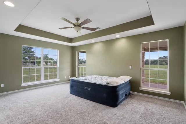 a living room with a bed and a window