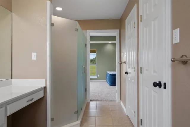 a view of a hallway with a bathroom