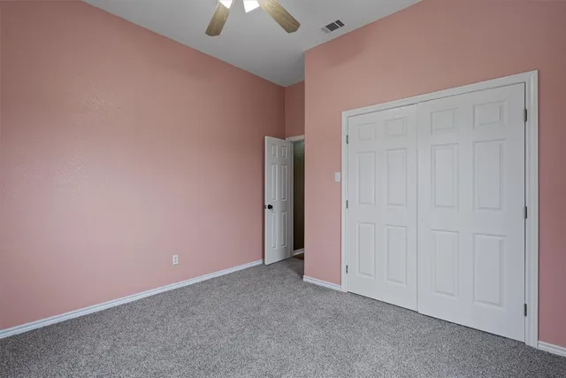 an empty room with closet area