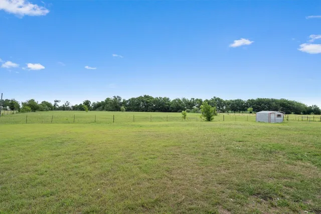a view of a lake with houses in the background