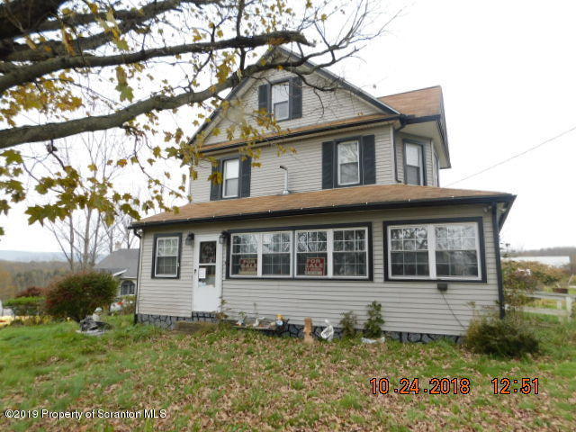 1693 Cortez Road Waymart, PA 18472 - Photo 1 of 29 a house that has a large tree in front of it
