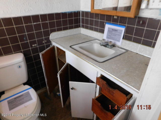 1693 Cortez Road Waymart, PA 18472 - Photo 14 of 29 a bathroom with a sink toilet and shower