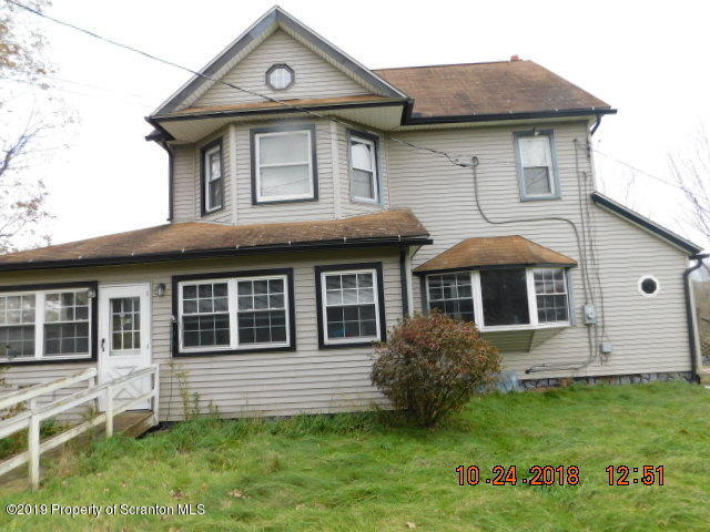 1693 Cortez Road Waymart, PA 18472 - Photo 3 of 29 a front view of a house with a yard
