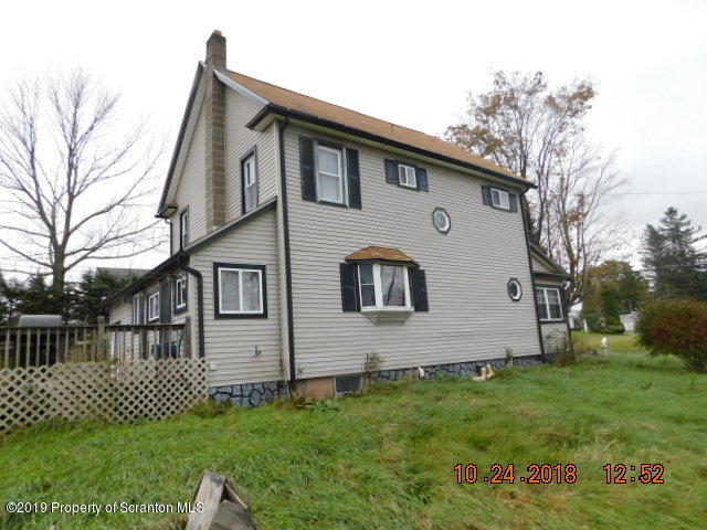 1693 Cortez Road Waymart, PA 18472 - Photo 5 of 29 a front view of a house with a garden