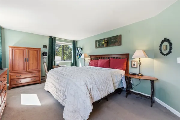 a bed sitting in a bedroom next to a window