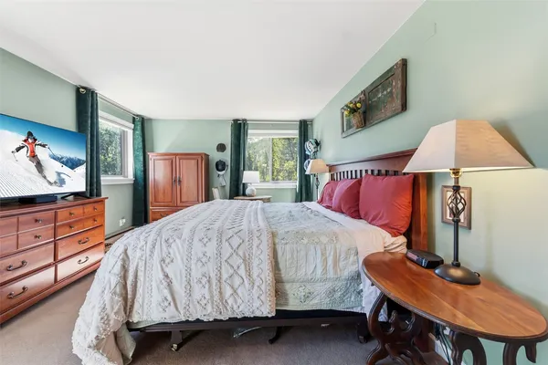 a bedroom with a bed and a dresser in it