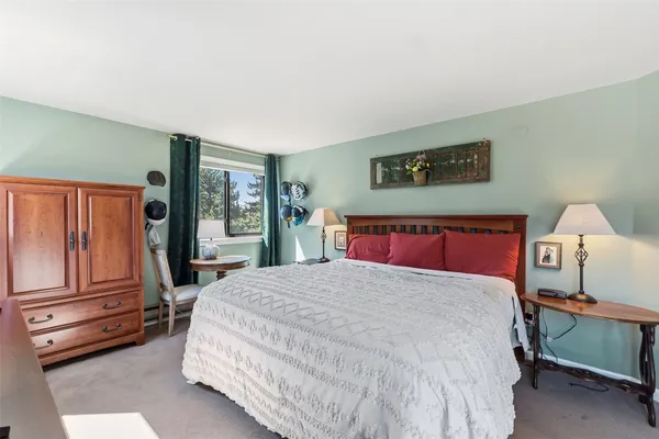 a bedroom with a large bed and window
