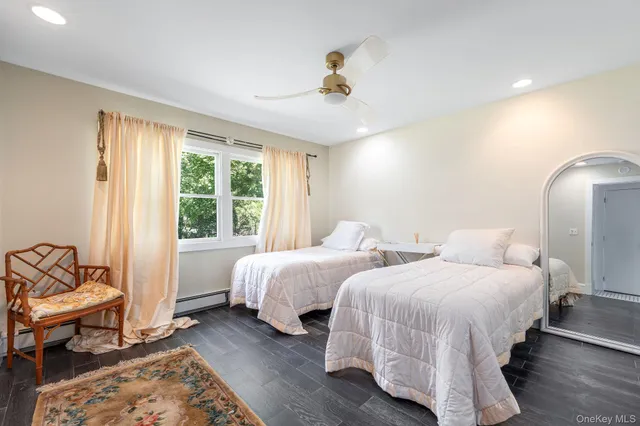 a bedroom with two beds and a window