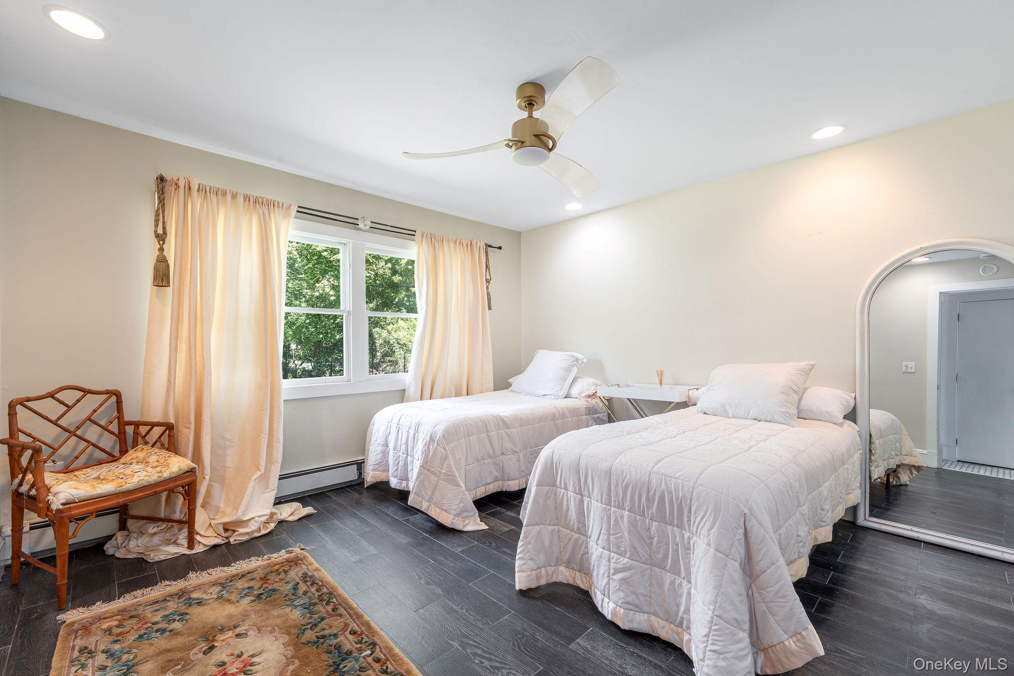 1 Gazon Road Shelter Island, NY 11964 - Photo 15 of 35 a bedroom with two beds and a window