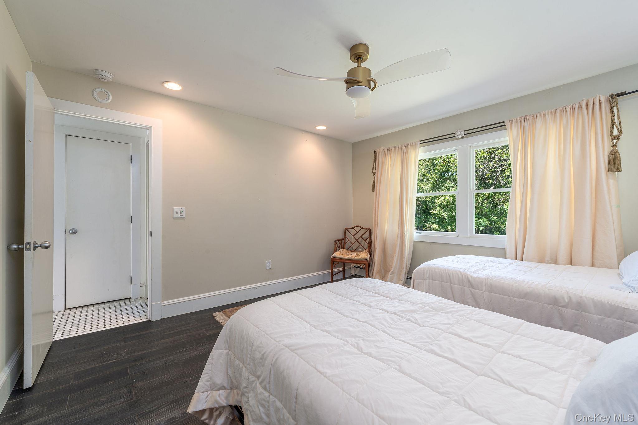 1 Gazon Road Shelter Island, NY 11964 - Photo 16 of 35 a bedroom with a large bed and wooden floor