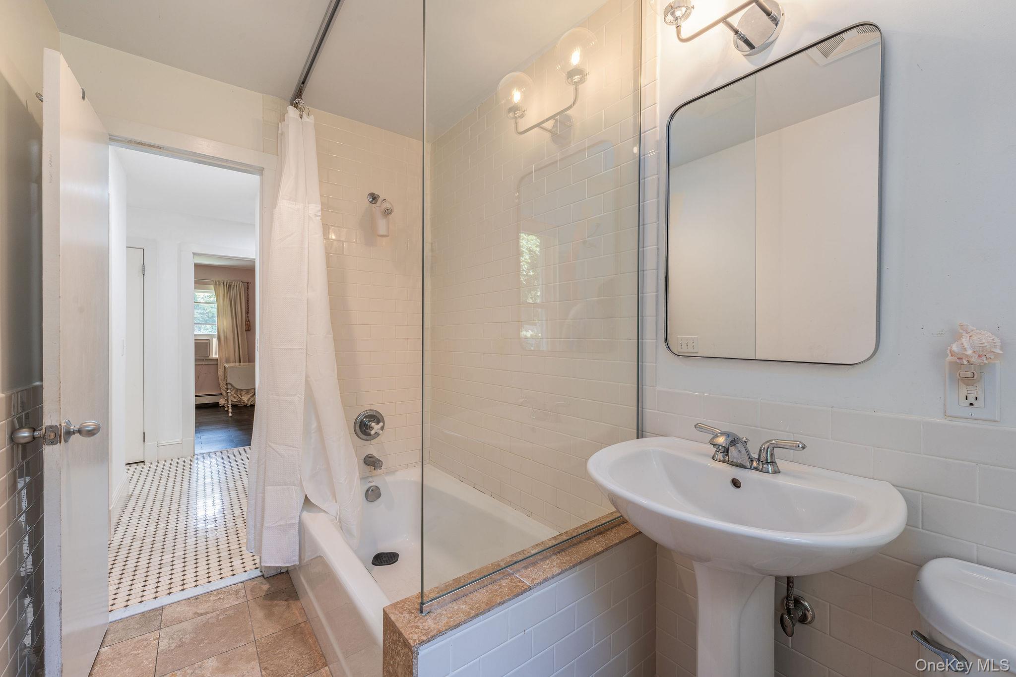 1 Gazon Road Shelter Island, NY 11964 - Photo 17 of 35 a bathroom with a sink a mirror and a shower