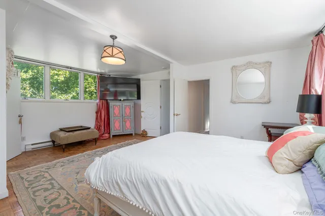 a bedroom with a bed and a large window