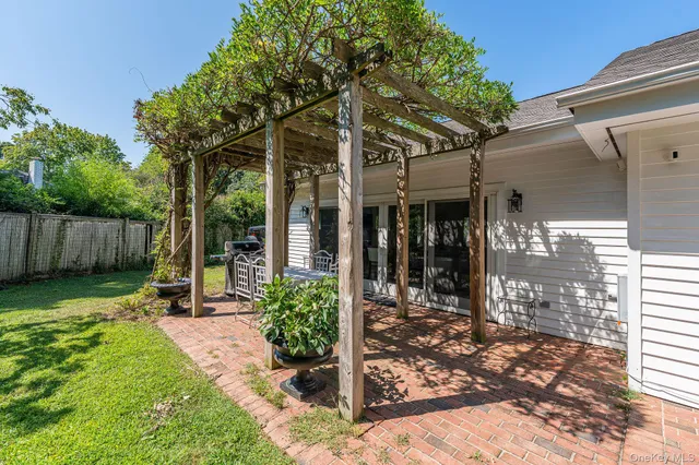 a view of a chair and table in backyard of the house