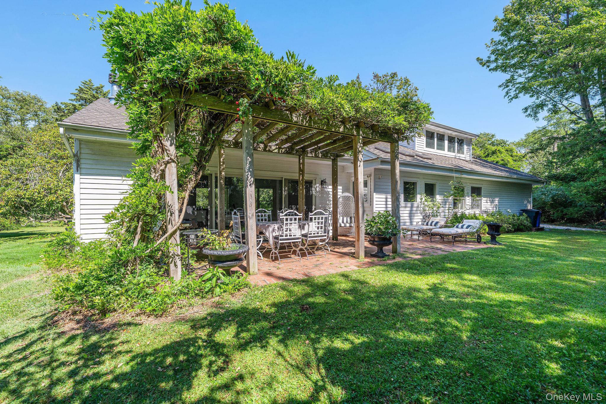 1 Gazon Road Shelter Island, NY 11964 - Photo 31 of 35 a view of a house with backyard porch and sitting area