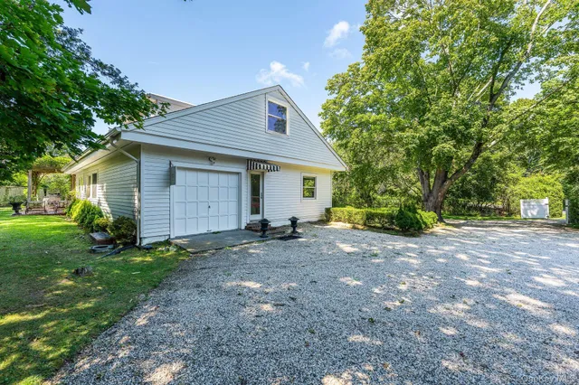 a view of a house with yard and a tree