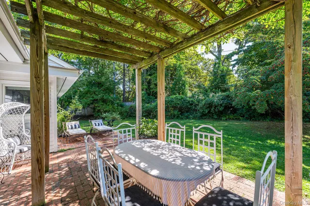 a view of a patio with a table chairs and a backyard