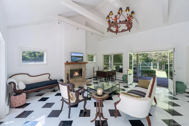 a living room with furniture a rug and a large window