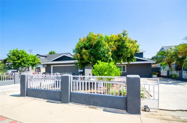 a view of a house with wooden deck and furniture